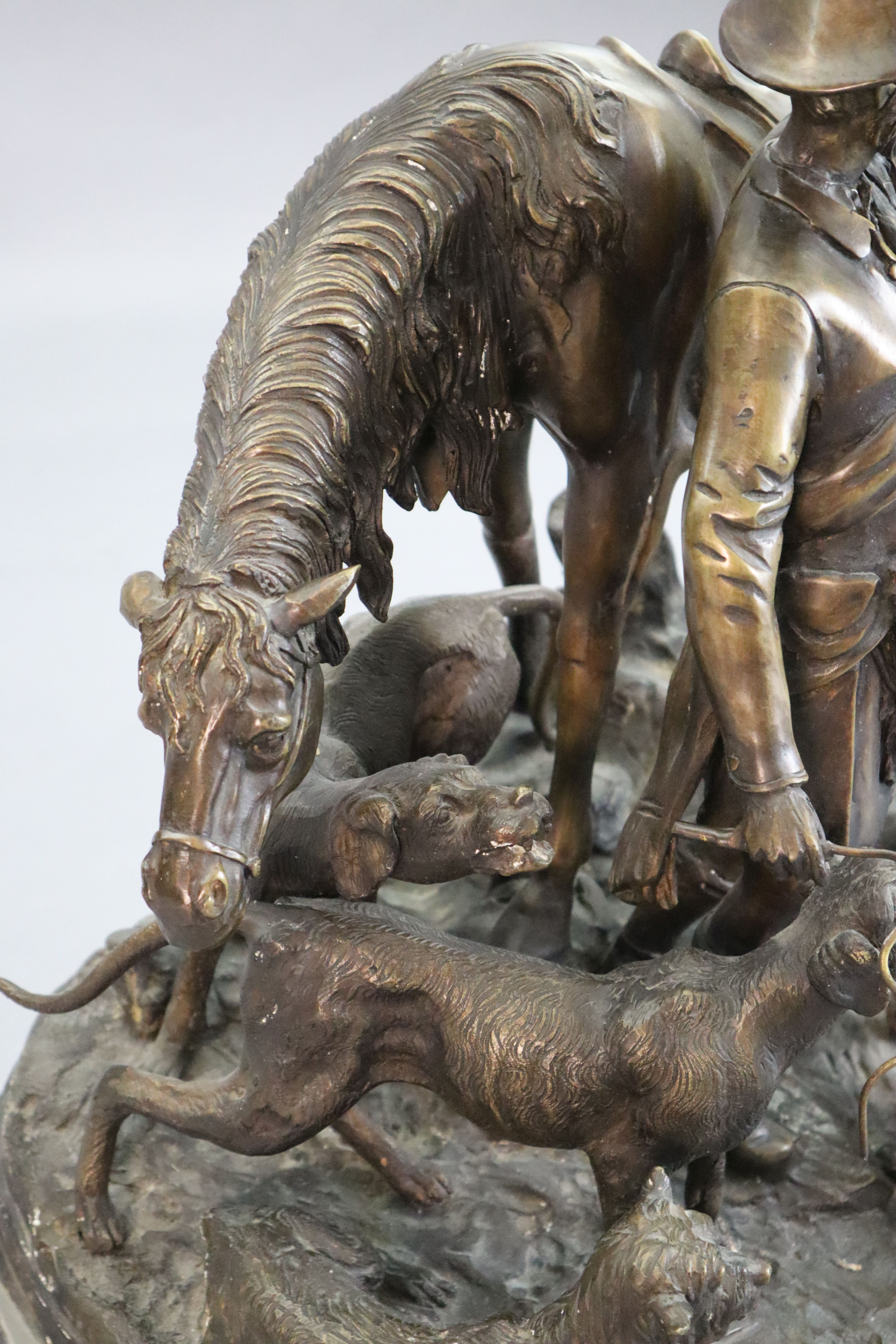 After Pierre Jules Mene. A bronze group of a ghillie, pony and hounds, width 23in. height 20in.